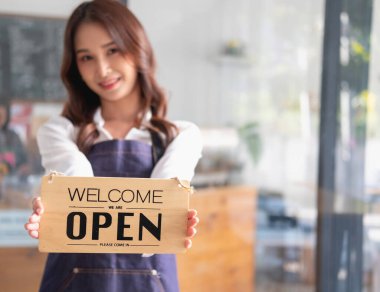 Portrait of a woman, a coffee shop business owner smiling beautifully and opening a coffee shop that is her own business, Small business concept.	