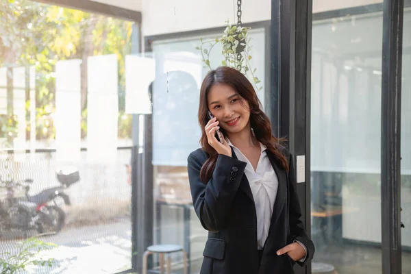 Marketing, Financial, Accounting, Planning, businesswoman uses a mobile phone to contact a customer to inform her of the company is business partnership.