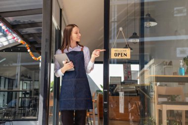 Portrait of a woman, a coffee shop business owner smiling beautifully and opening a coffee shop that is her own business, Small business concept.	 clipart