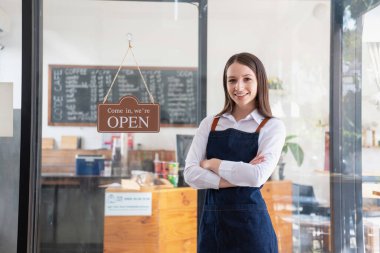 Portrait of a woman, a coffee shop business owner smiling beautifully and opening a coffee shop that is her own business, Small business concept.	