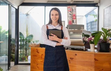 Portrait of a woman, a coffee shop business owner smiling beautifully and opening a coffee shop that is her own business, Small business concept.	