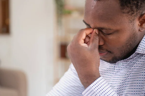 stock image An American businessman with black skin in Africa feels uncomfortable at work and wrist pain is caused by the accumulated stress from failing to complete the job. and the body rests a little. 