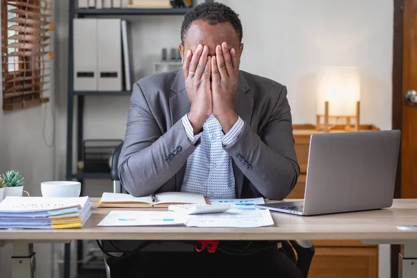 stock image Concept Burnout Syndrome. African American businessman feels uncomfortable working, which is caused by stress, accumulated from unsuccessful work And less rest body. Consult a specialist psychiatrist.