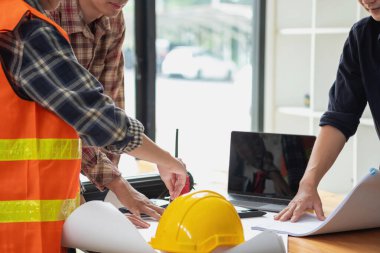 İş sahasında modeller ve planlar oluşturmak için ortaklar ve mühendislik araçlarıyla çalışan mühendisler için mühendisler veya mimarlarla görüşmeyi kabul et. İnşaat konsepti Mühendis kavramı.