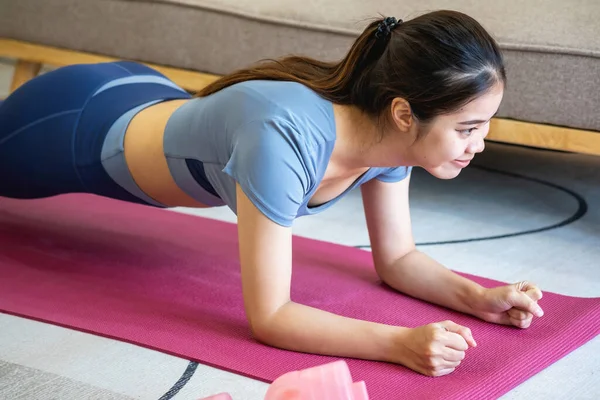 Women are stretching, at home, and fitness Women exercise or do yoga in their bedroom for health and wellness a healthy, calm female person training or working on the house floor.