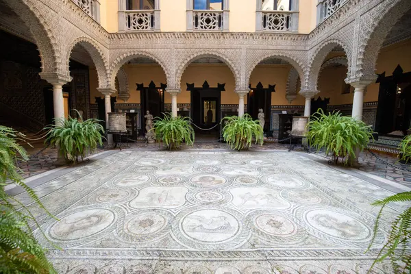 Palmiye ağaçları, saksıları ve sütunları olan iç avlu, Sevilla, İspanya