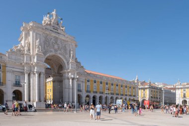 main gate of the Lisbon Commerce Square with people strolling by, Portugal