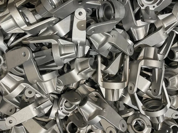 bulk aluminum forks, lot of die cast aluminum parts placed on mass, automotive parts mass production, mass production of die casting parts, aluminum die cast parts mass production