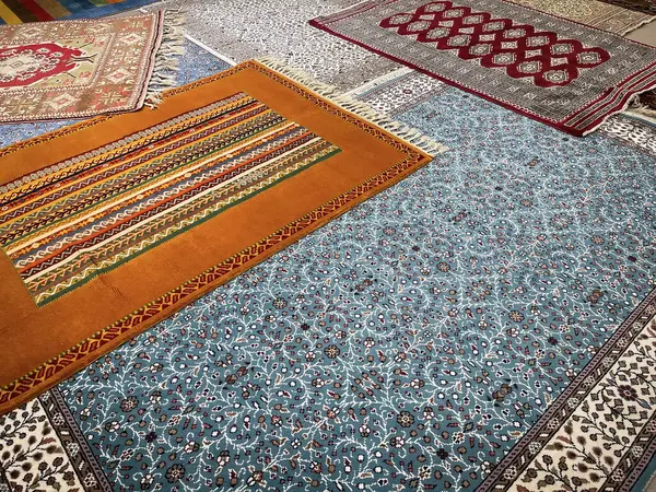 a sample of five handmade wool and silk carpets, typical turkish handmade kilim carpets and rugs in a Turkish carpet store, horizontal
