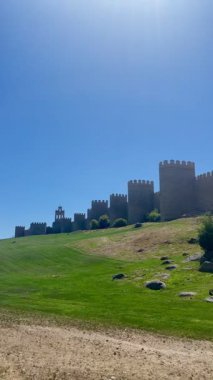 İspanya 'nın Avila kentini çevreleyen muazzam ortaçağ duvarı ve kulelerinin 4k panoramik görüntüsü