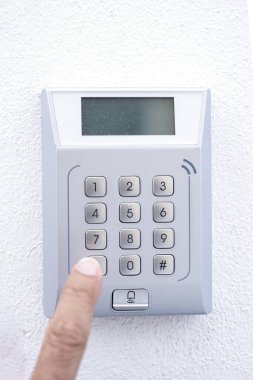 bir güvenlik sistemi veya giriş kapısı için sayısal tuş takımındaki bir tuşa basıldığında, panel beyaz bir duvara monte edilir
