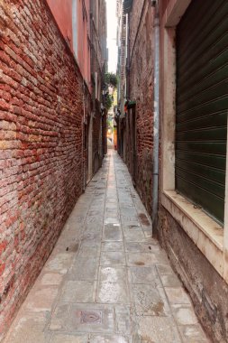 Narrow traditional passage between houses in Venice.
