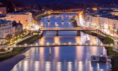 Picturesque view of the old city against the backdrop of bridges across the river at sunset. Salzburg. Austria.
