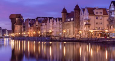 The old embankment of the city and the facades of medieval houses at sunset. Gdansk. Poland.