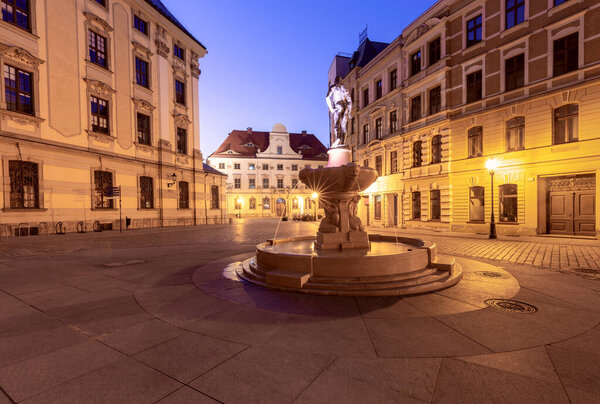 University Square with a fountain in Wroclaw at dawn.