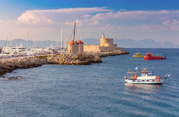 Gün batımında Mandrak limanındaki eski deniz fenerinin manzarası. Rodos. Yunanistan.