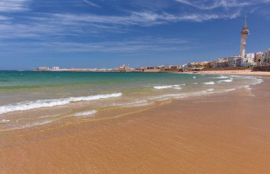 Güneşli bir günde kumlu sahil ve Atlantik Okyanusu manzarası, Cadiz, İspanya, Endülüs.