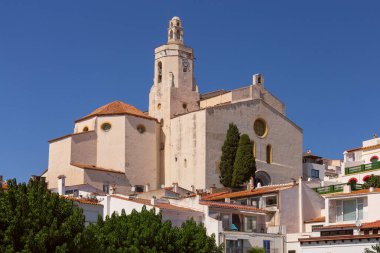 Church of Santa Maria in Cadaques, white walls and bell tower stand out against the clear blue sky, Spain, Catalonia clipart