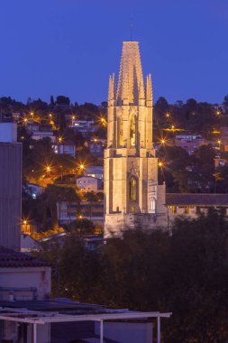 Evening view of the bell tower of the church of Sant Feliu in Girona at dawn, Spain. clipart