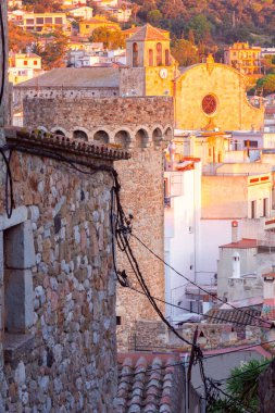 İspanya 'nın Katalonya kentindeki tarihi Tossa de Mar kasabasının manzarası, ortaçağ kuleleri, taş duvarları ve geleneksel Akdeniz evleri