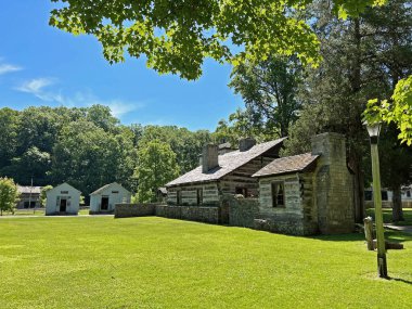 Mitchell, Indiana yakınlarındaki Spring Mill State Park 'taki 1800 Pioneer Village' da yeniden inşa edilmiş ve restore edilmiş tarihi eczane, Mercantile ve Lower Residence dergisi. Güzel mavi gökyüzü ve canlı yeşil ağaçlar ve çimen kopyalama alanı..