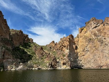 View from a steamboat, of Canyon Lake reservoir and rock formations in Maricopa County, Arizona in the Superstition Wilderness of Tonto National Forest near Apache Trail. The lake was formed by damming the Salt River as part of Salt River Project. clipart