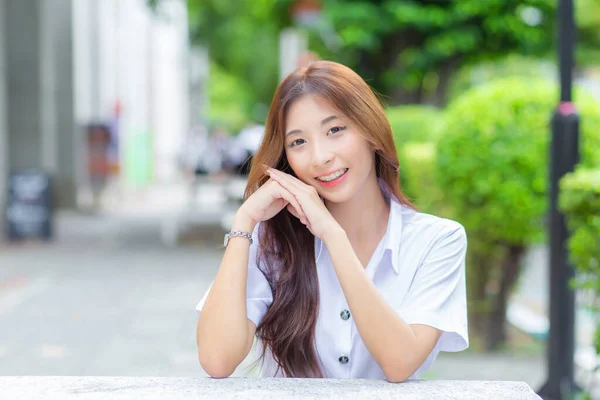 Young Thai University Student Girl Wearing Student Uniform While Sitting — Zdjęcie stockowe