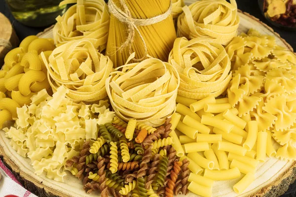 stock image Assortment of dried pasta, Place for text. Mix of different and raw pasta, Side view. Place for text