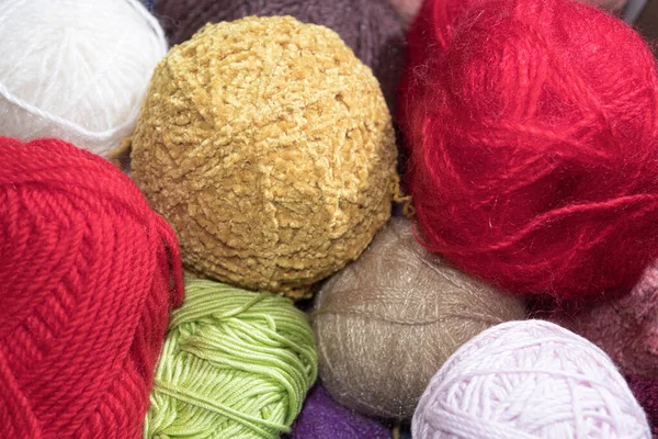 Multi-colored balls of knitting threads. Balls of colored yarn. Woolen yarn in balls, different colors