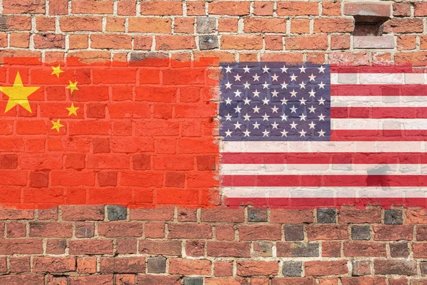 Flag of America and China painted on a brick wall. Flag on a stone wall. Brick wall and USA and China flags