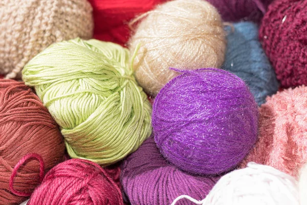 Multi-colored balls of knitting threads. Balls of colored yarn. Woolen yarn in balls, different colors