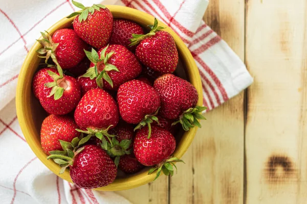 stock image Fresh strawberries on a wooden table, close-up. View from the mountain. Juicy strawberries lie on a wooden table. Copy space