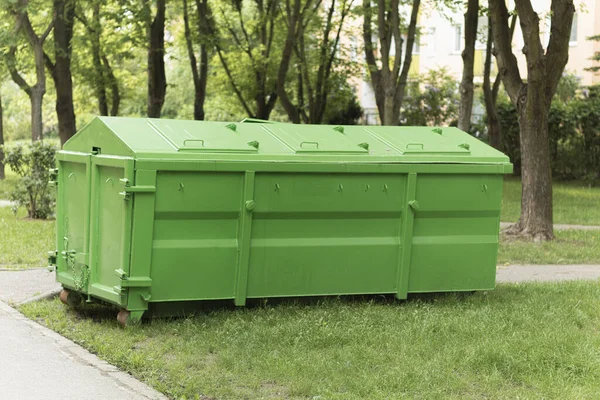 A large container for washing and construction waste. A garbage can for garbage in the yard. A dumpster full of junk on the street. Industrial and household waste