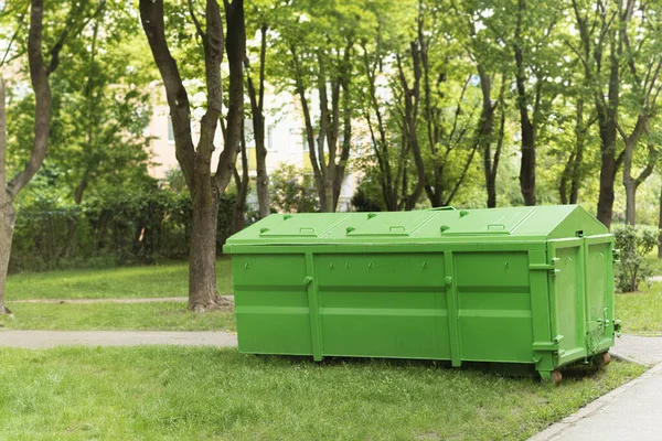 A large container for washing and construction waste. A garbage can for garbage in the yard. A dumpster full of junk on the street. Industrial and household waste