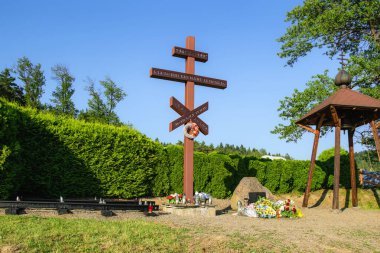 Zdynia, Poland - 15 July , 2023: Monument commemorating the 50th anniversary of the resettlement of people of Lemko and Ukrainian origin from the lands of southern Poland clipart