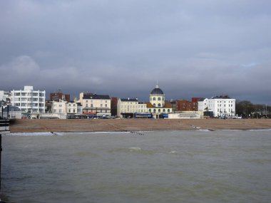 View from the sea to the beach, shore and city buildings