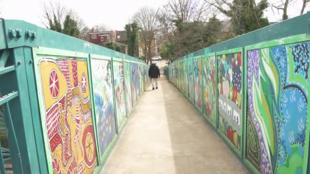 Man Walking Footbridge Crossing Colourful Murals London — Stock Video