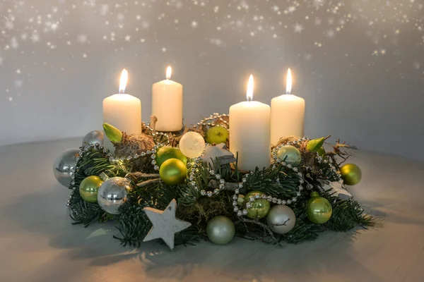 第四修院 桌上放四支燃烧的白色蜡烛和绿色圣诞装饰品 第四个星期日的室内装饰 复制空间 选定焦点 狭窄的场地深度 — 图库照片