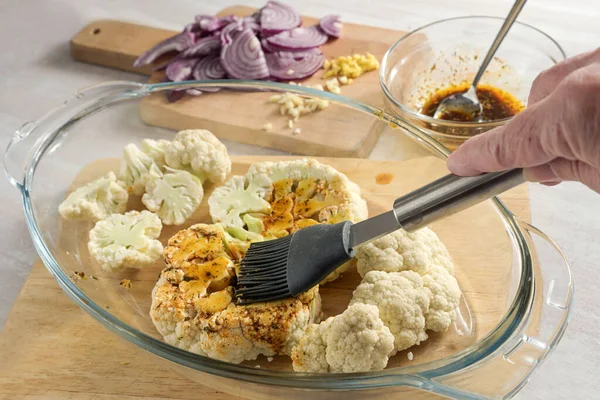 Hand Silicone Brush Spreading Spice Oil Raw Cauliflower Slices Glass — Stock Photo, Image