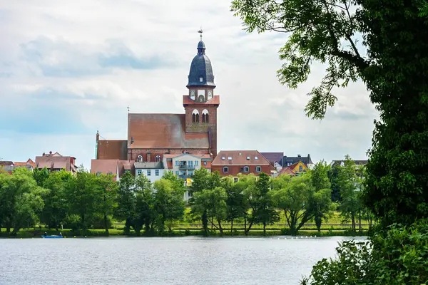 stock image Waren (Muritz) with the St. Mary's church (Marienkirche) in the old town, seen from the lake Tiefwarensee, landmark and tourism destination in the Mecklenburg lake district, copy space