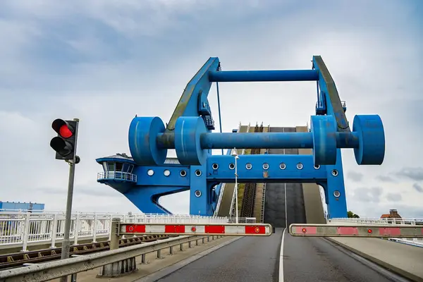 stock image Wolgast Peene Bridge with raised roadway, bascule bridge connecting the island of Usedom with the mainland of Western Pomerania. The bridge is also called Blue Wonder. Copy space