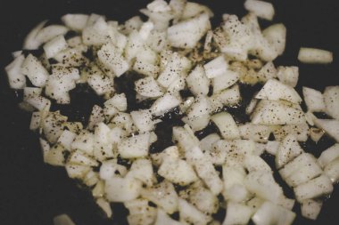 Fry onions in a frying pan.