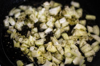 Fry onions in a frying pan.