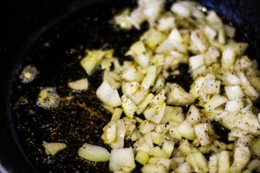 Fry onions in a frying pan.