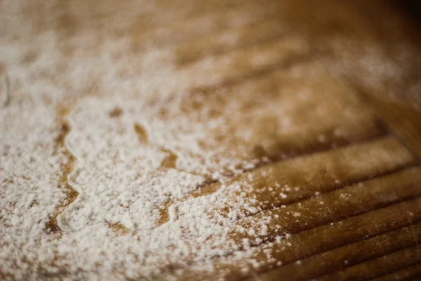 Ingredients for cooking Christmas baking: fir tree made from flour on a light table, kitchen utensils, top view.