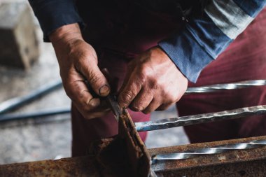 Processing of metal. A man welds a metal with a welding machine, profession of welder, weld metal.
