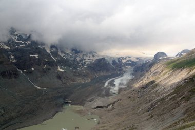 Mountain snow panorama with glacier Pasterze and clouds in High Tauern Alps, Austria