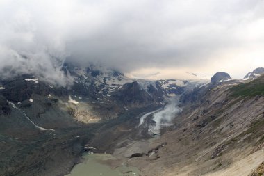 Mountain snow panorama with glacier Pasterze and clouds in High Tauern Alps, Austria