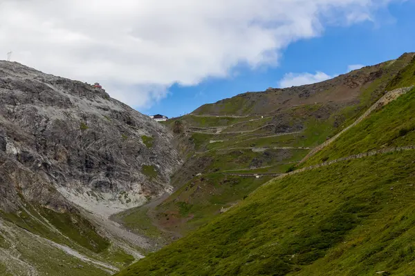 stock image Serpentine road, summit of Stelvio Pass and mountain alps panorama in Italy