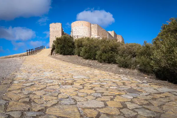 Stock image Castle palace of Jadraque on the top of the hill on a blue sky day with clouds, Guadalajara, Spain